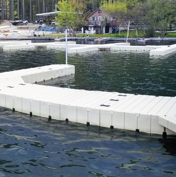 Dock sections on lake with cabin in background