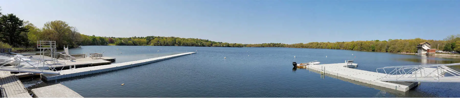 View of lake with 2 floating docks and tree line