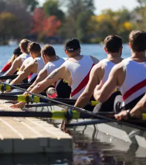 Rowing team pushing off a low profile dock