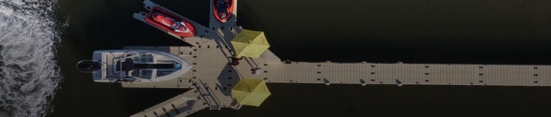 Overhead view of 3 jet skis parked on boat port