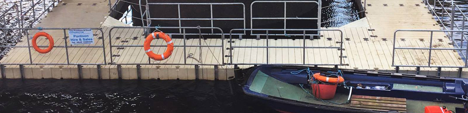 Floating dock with safety equipment and railings