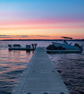 Dock with seating and boat port at sunset