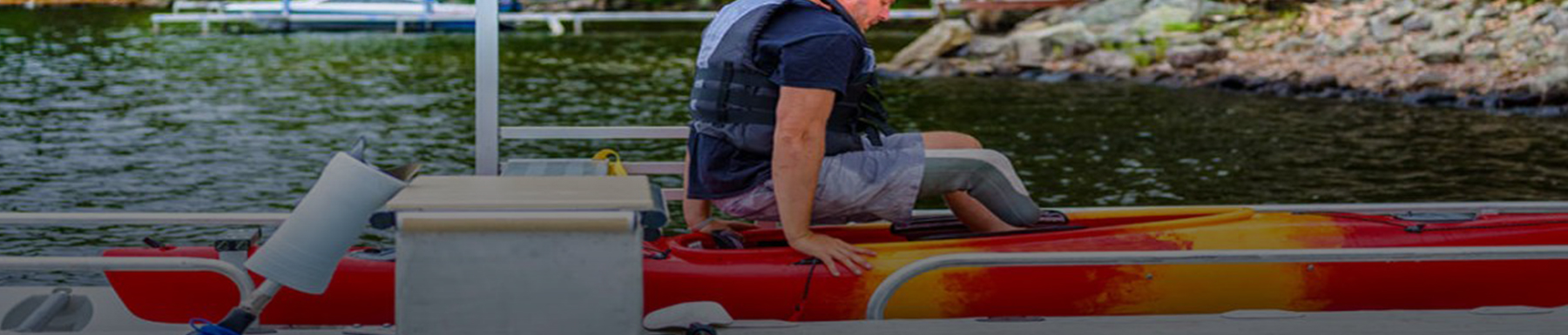 Man preparing to sit in kayak