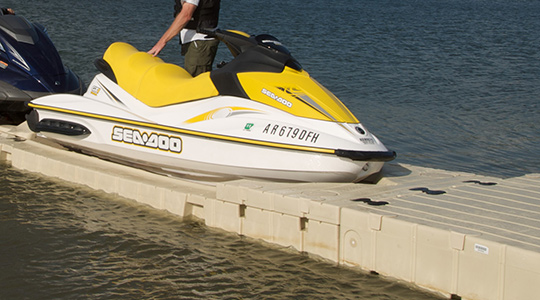 A yellow jet ski is docked in a port