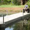 A man drives his ATV on his floating poly dock