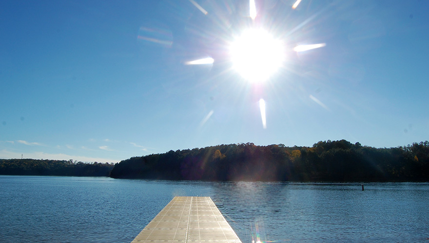 The sun shines brightly over a dock