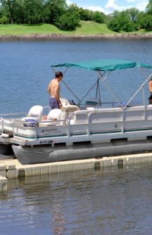 A family sits on their boat as they prepare to launch from their dock