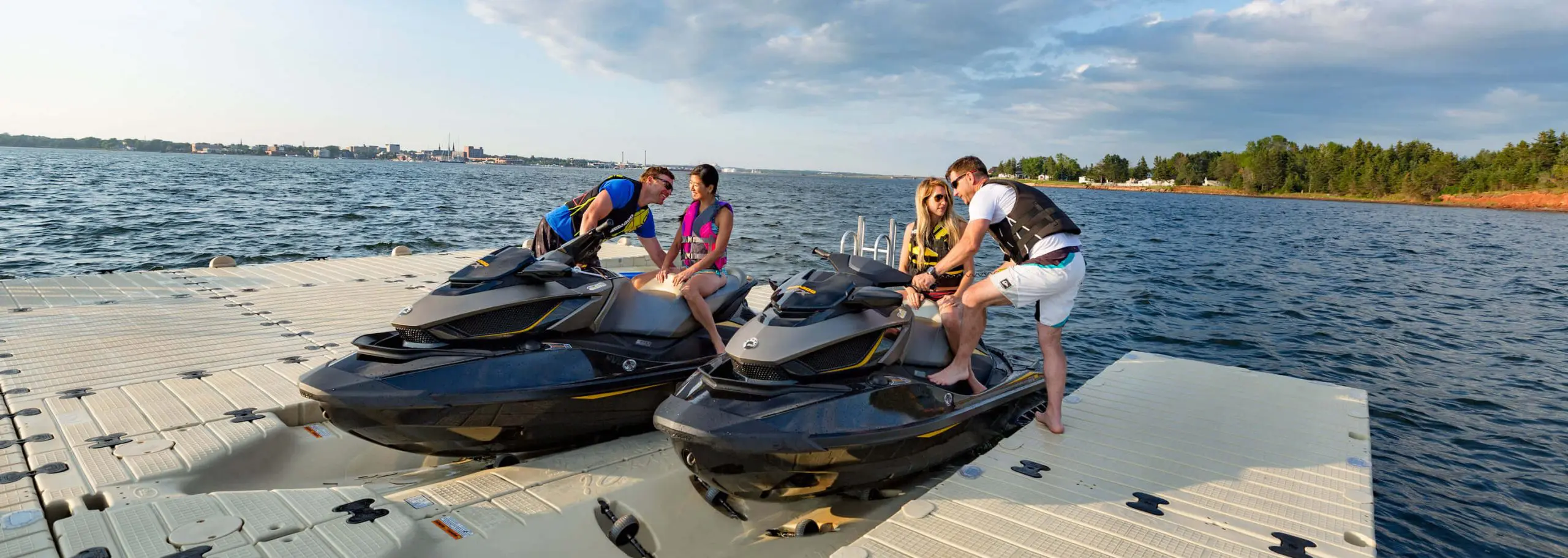 Two couples mounting on 2 jet skis