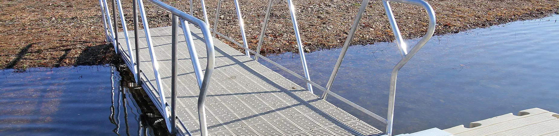 Walkway with railing connecting to dock