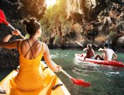 3 people kayaking in canyon