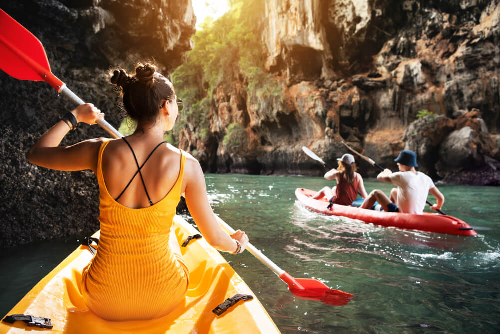 3 people kayaking in canyon