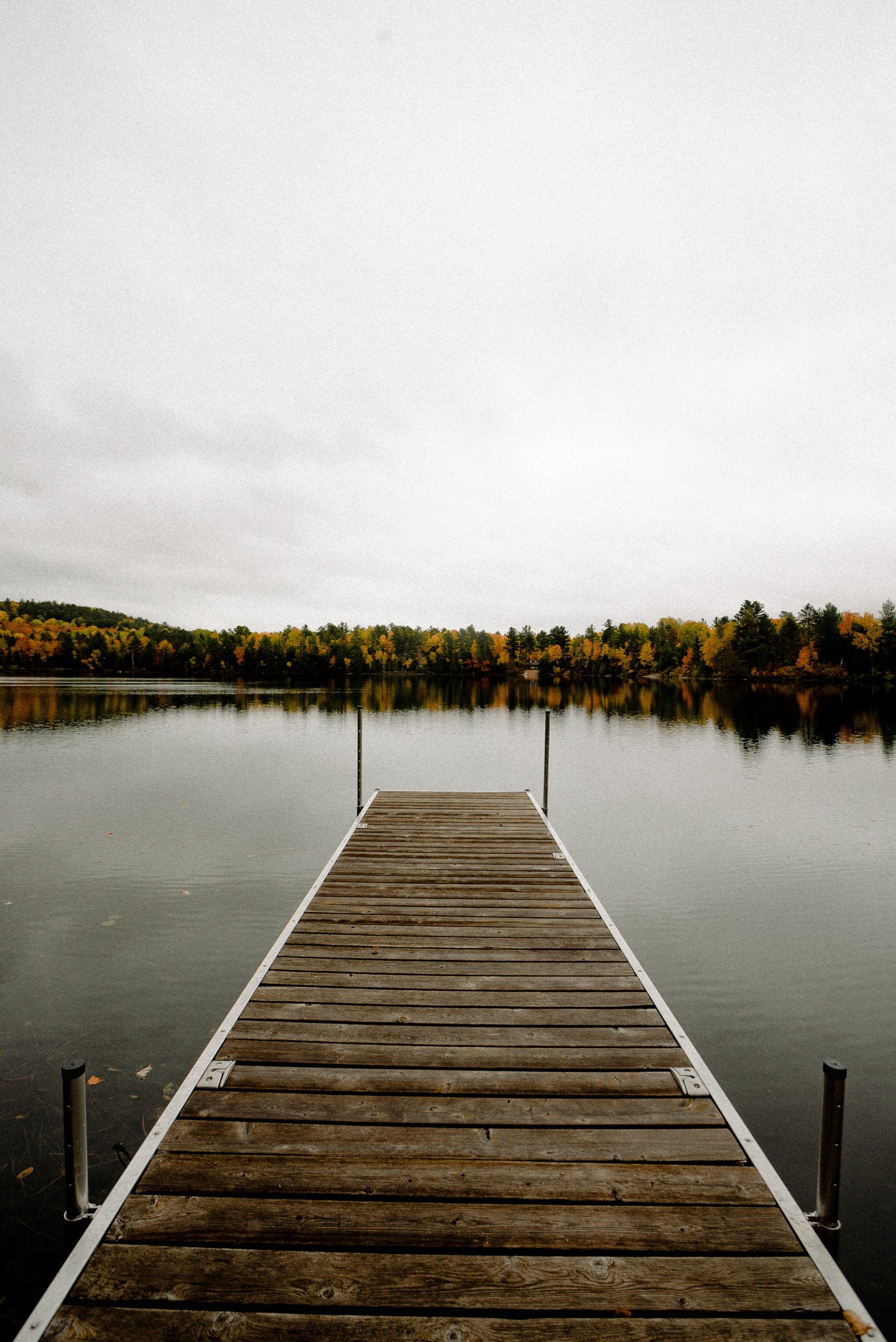 Scenic fall view of lake on wooden dock