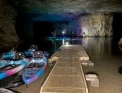 Spelunkers paddleboarding in cave