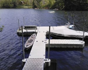 Floating dock on a forest lake with cabin