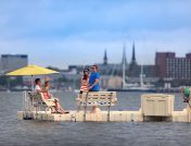 2 couples on floating dock across from city