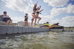 Girls Jumping in water from dock