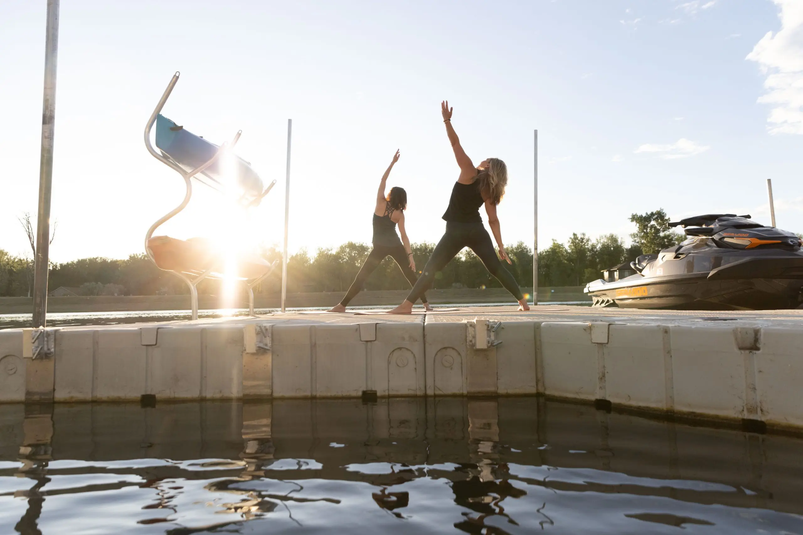 Women doing yoga on dock