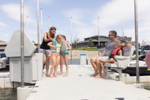 Children playing on the dock with parents
