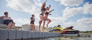 2 girls jumping off floating dock