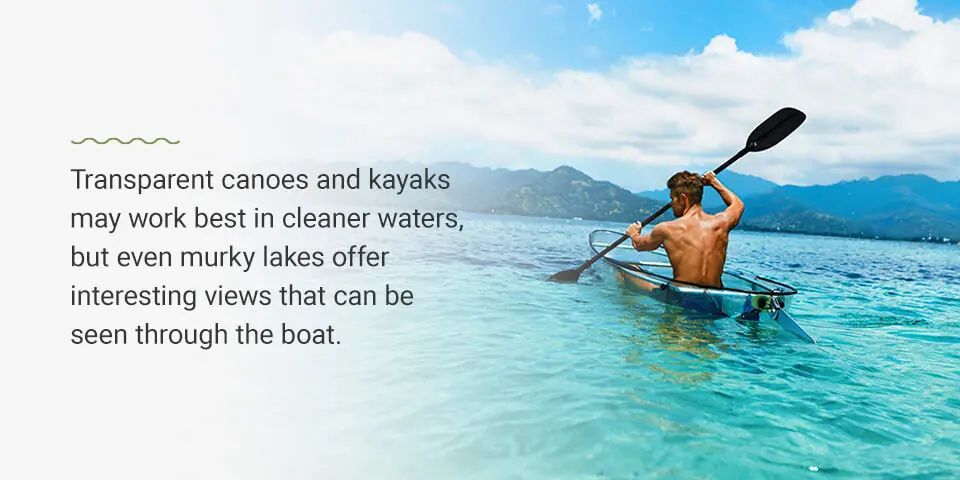 A man paddles a transparent kayak through clear blue water