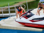Young couple moving a jet ski from a dock into the water in Indiana