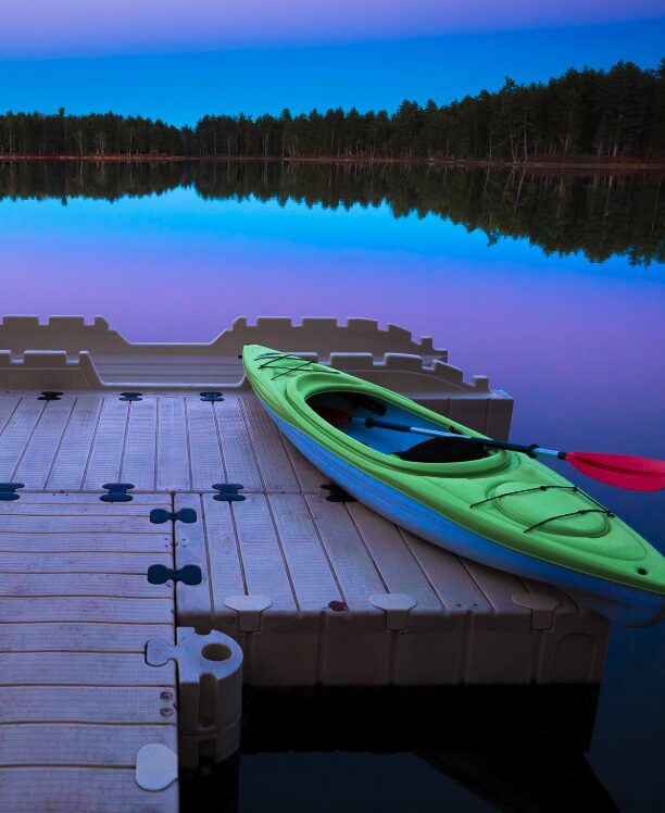 kayak on a glassy smooth lake at time of sunset