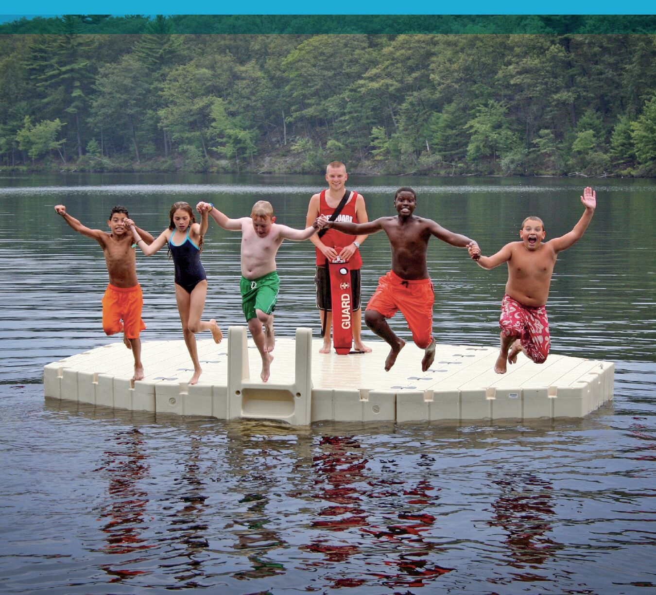EZ Docks Camps brochure cover, kids jumping into lake from a floating dock