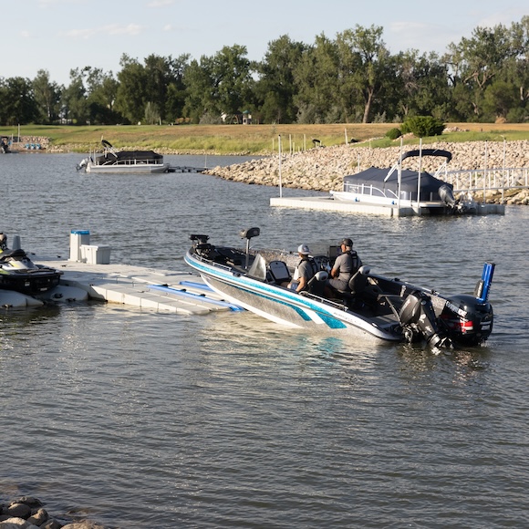 outboard motorboat docking on a ramped floating dry dock